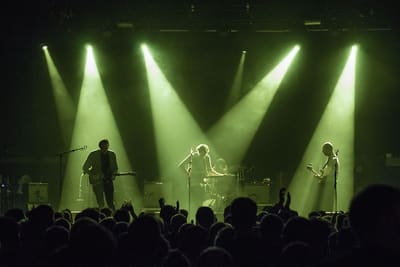 Real Estate performing live under dramatic stage lights