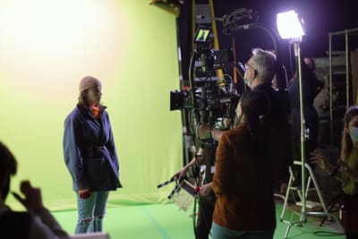 Actor in a green screen studio filming a scene