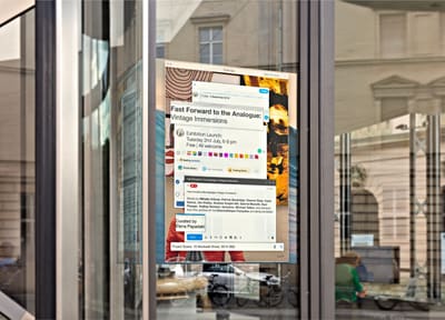Exhibition poster on the window of the University of Greenwich Gallery